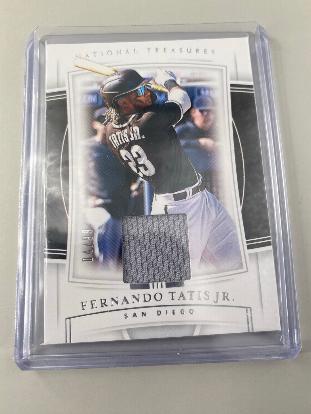 Fernando Tatis Jr. National Treasures #100 player-worn material 04/99 close-up