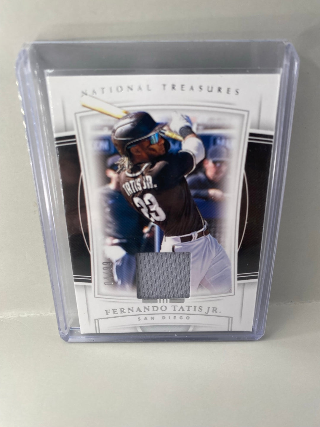 2020 Panini National Treasures Fernando Tatis Jr. #100 player-worn material 04/99 front